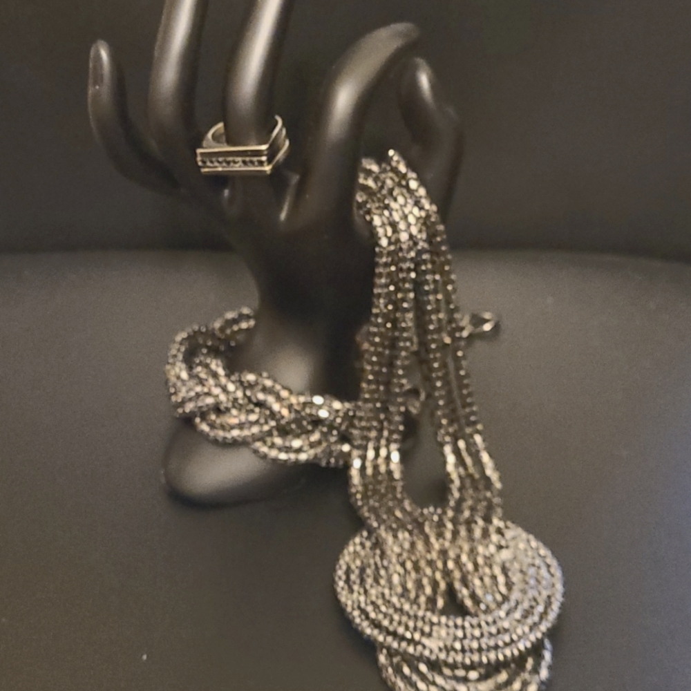 Metal sparkly necklace, bracelet and rings.